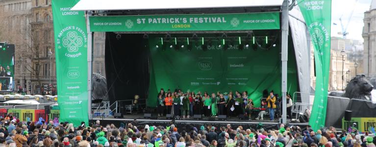 Photo of main stage with a crowd of people in front of it.