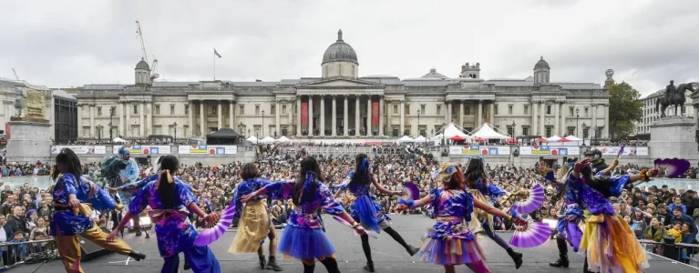 Image taken from stage at Trafalgar Square of backs of dancers and crowd watching. 