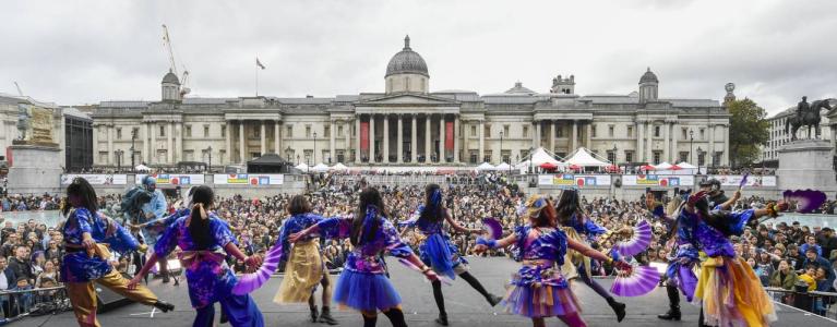 Image taken from stage at Trafalgar Square of backs of dancers and crowd watching.