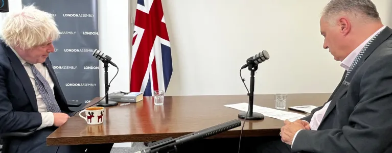 Two men at table talking