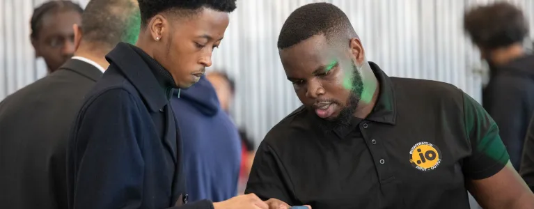 Two young men looking at a mobile phone