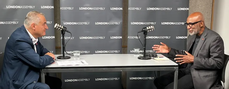 two men at table talking