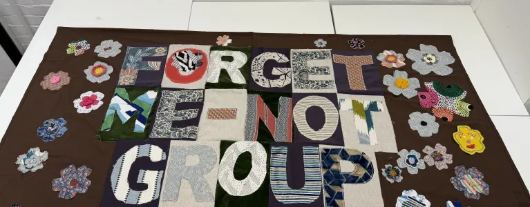 Material was donated from a local charity and each flower was made by and represents a group member.