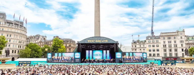Cast of Mamma Mia on stage and view of the crowd at West End LIVE on Trafalgar Square, 2025
