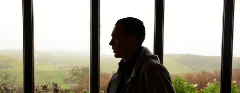 Man in front of window