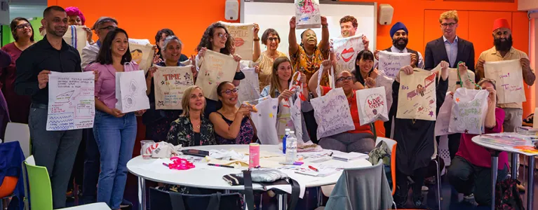 Vanessa Damali with a workshop group showing their customised tote bags