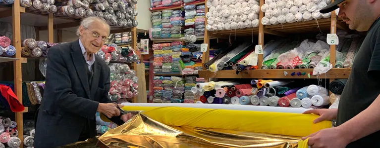 Tailor cutting fabric