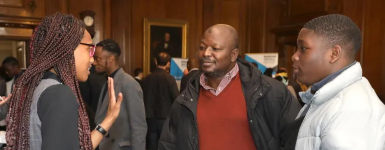 Two men asking for information at event