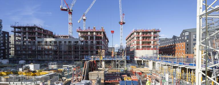 A construction site in London including crane and construction site workers
