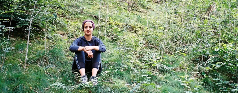 Volunteer sitting around greenery