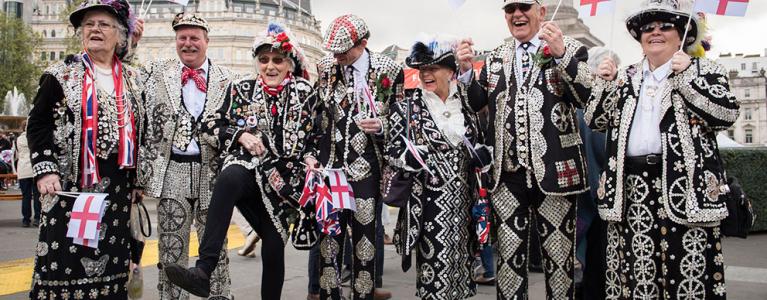 Pearly kings and queens waving flags at the Feast of St.George
