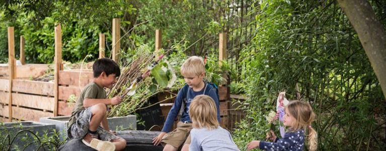 Children on a tire in a garden