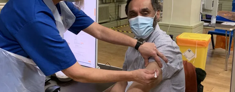 Dr Onkar Sahota AM recieving first vaccine dose