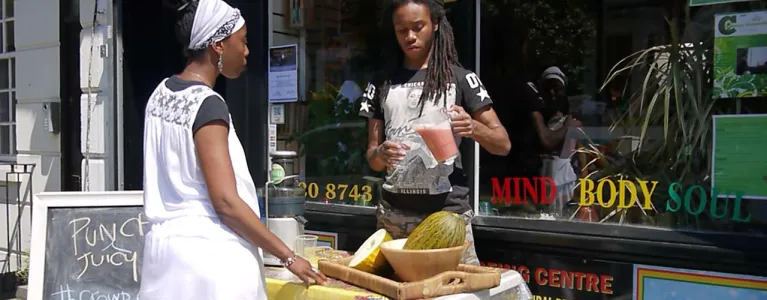 A man pouring juice outside 'Punch and Juicy'
