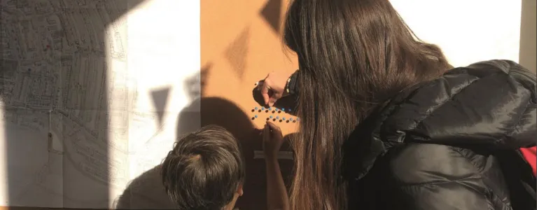 Mother and son looking at notice board