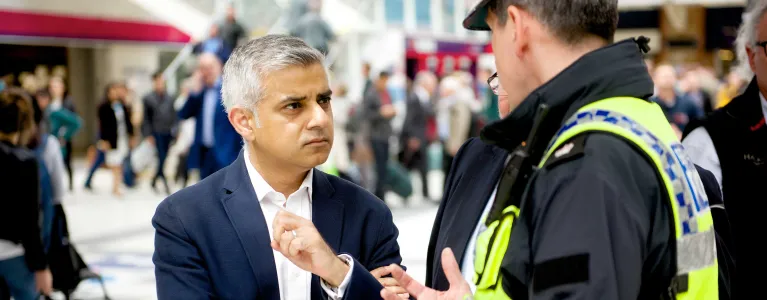 Mayor of London Sadiq Khan speaks with a police officer at Liverpool Street station