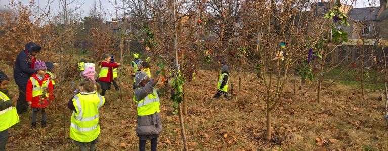 Children dressing trees for winter