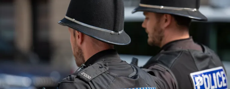 Two police officers walk side by side