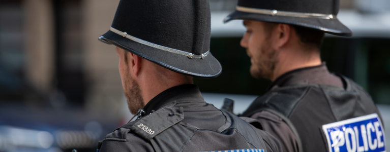 Two police officers walk side by side