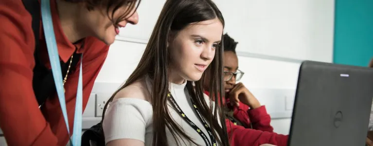 Two students studying tech