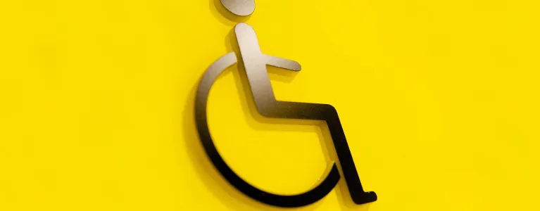 Person on wheelchair icon on yellow background