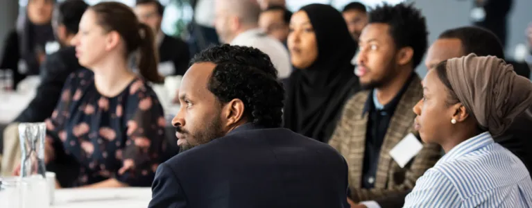 group of people listening to someone out of frame