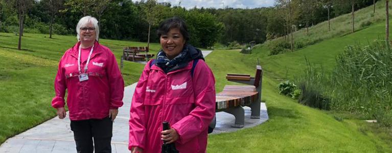 Volunteer in pink uniform at the London Blossom Garden