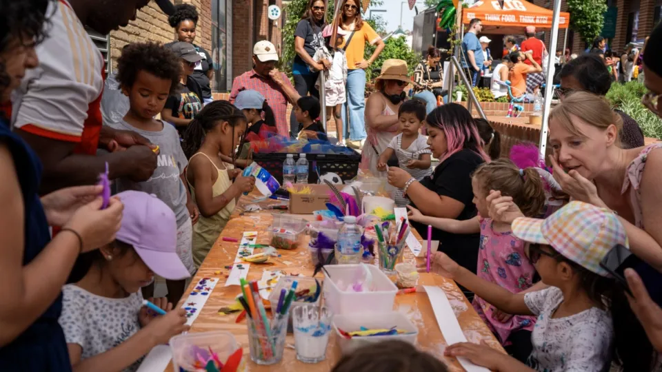 Children making crafts at a table outdoors, photo by Dave Reeve