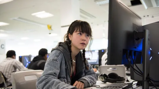 Young woman sitting at a desk and using a computer