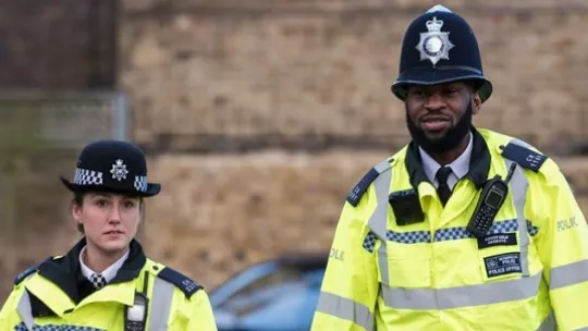 One male and one female police officer on foot patrol