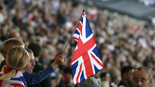 Union Jack flag raised and held in a crowd