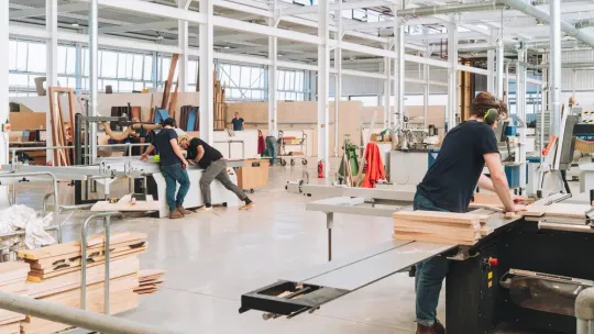 Wood workers using wood working equipment and tools