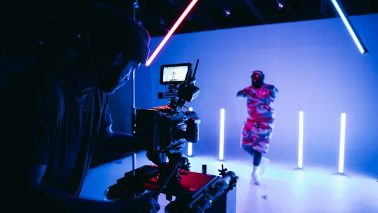 a man filming a man dancing 