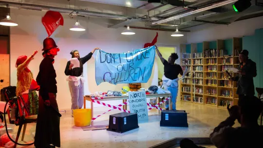 A community performance in a library campaigning for clean air