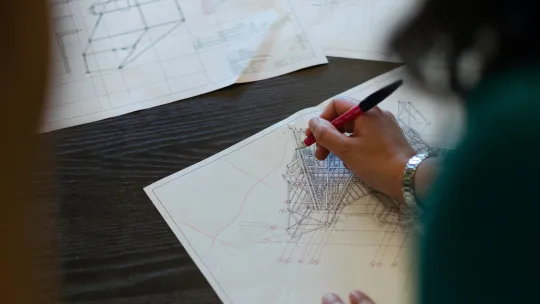 a man drawing on paper
