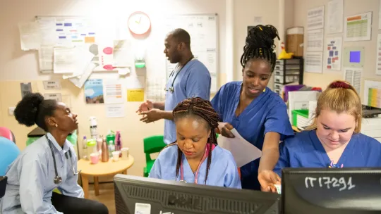 A group of nurses in an office talking