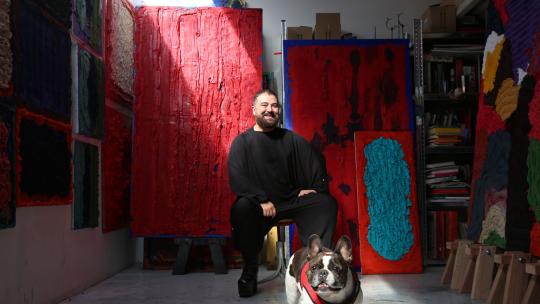 Artist in their studio with their dog