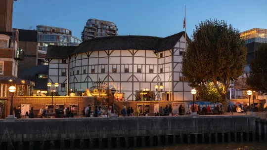 The outside of the globe theatre in London at night