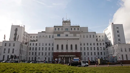 Large building with grass in the foreground