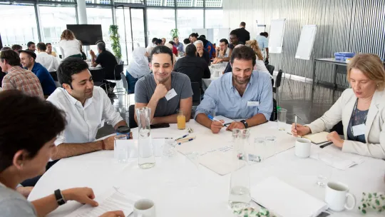 Photo showing a group of refugees participating in a workshop