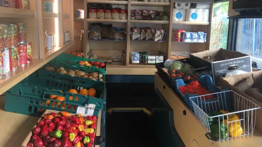 Food bus interior displaying fruits and vegetables
