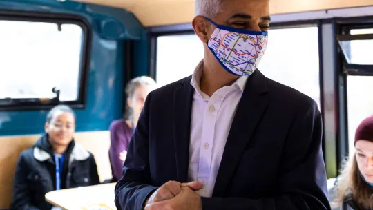 Mayor speaking to community inside the bus during launch event