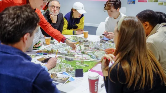 Image showing people sitting around a table with a map on it