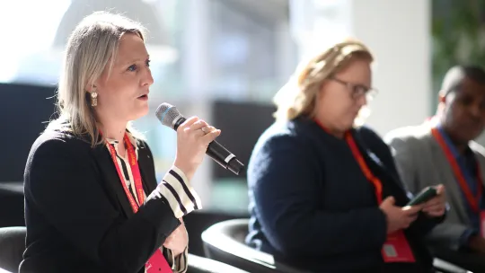 Katherine Chapman from Living Wage Foundation speaking on stage into a microphone