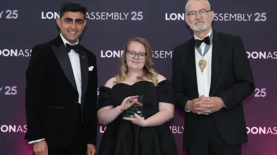 Three people smiling towards camera