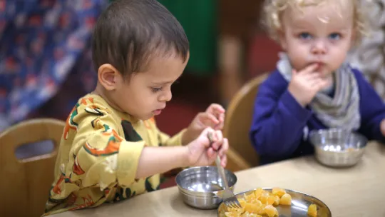 Young children eating oranges