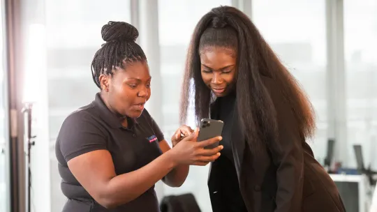 Two young women looking at a mobile phone