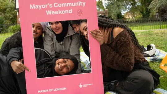 We Restart volunteers on picnic blanket in MCW 2025 picture frame 