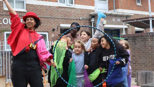 Street performer with children at Brixton People’s Kitchen event 