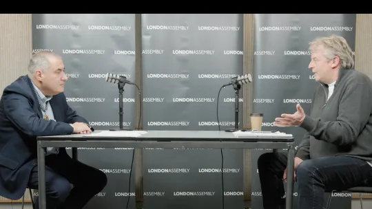 two men talking into mic